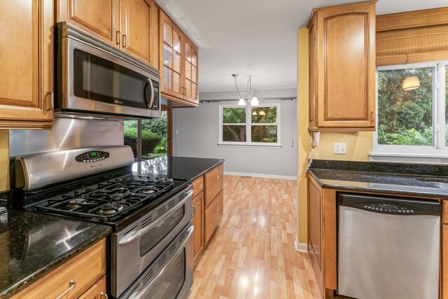 57 Kenilworth Ave, Elk Grove Village, IL 60007 - kitchen with stainless steel appliances, light wood-type flooring, glass insert cabinets, and dark stone counters