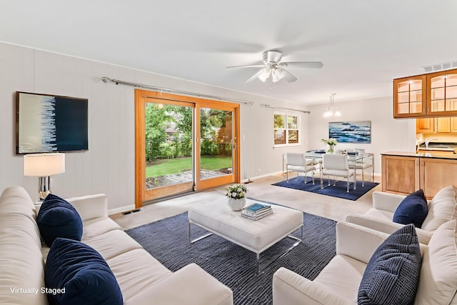 57 Kenilworth Ave, Elk Grove Village, IL 60007 - carpeted living room featuring a ceiling fan and a chandelier