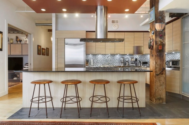 215 W Illinois St Unit 4C, Chicago, IL 60654 - kitchen featuring ventilation hood, tasteful backsplash, a breakfast bar, dark countertops, and recessed lighting