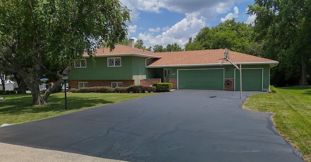 10S125 Springbrook Dr, Naperville, IL 60565 - tri-level home featuring asphalt driveway, an attached garage, and a front yard
