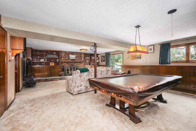10S125 Springbrook Dr, Naperville, IL 60565 - playroom featuring wood walls, light colored carpet, billiards, a fireplace, and a textured ceiling