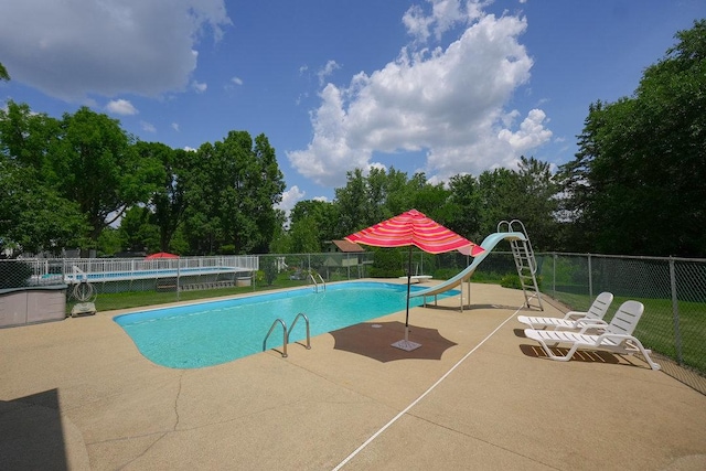 10S125 Springbrook Dr, Naperville, IL 60565 - view of swimming pool featuring a water slide, a patio, view of scattered trees, and a diving board