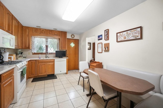 10S125 Springbrook Dr, Naperville, IL 60565 - kitchen featuring white appliances, light countertops, light tile patterned flooring, and brown cabinetry