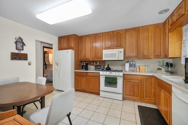 10S125 Springbrook Dr, Naperville, IL 60565 - kitchen with white appliances, light tile patterned floors, light countertops, and brown cabinets