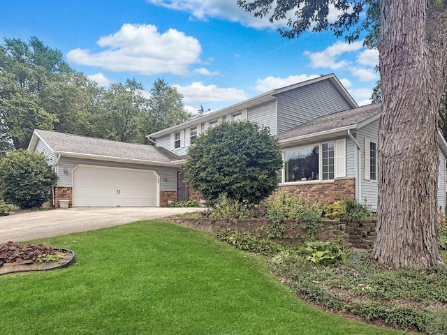 1607 Parkside Ct, Freeport, IL 61032 - view of front of home with brick siding, an attached garage, a front yard, and concrete driveway