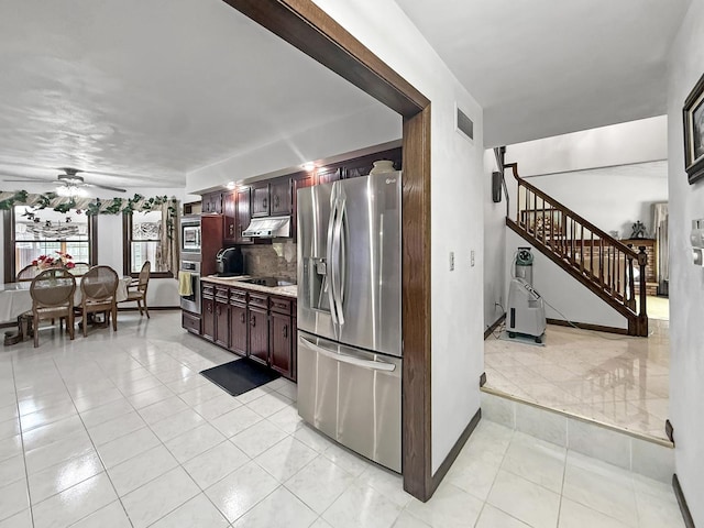1607 Parkside Ct, Freeport, IL 61032 - kitchen with stainless steel fridge with ice dispenser, under cabinet range hood, light countertops, light tile patterned floors, and ceiling fan