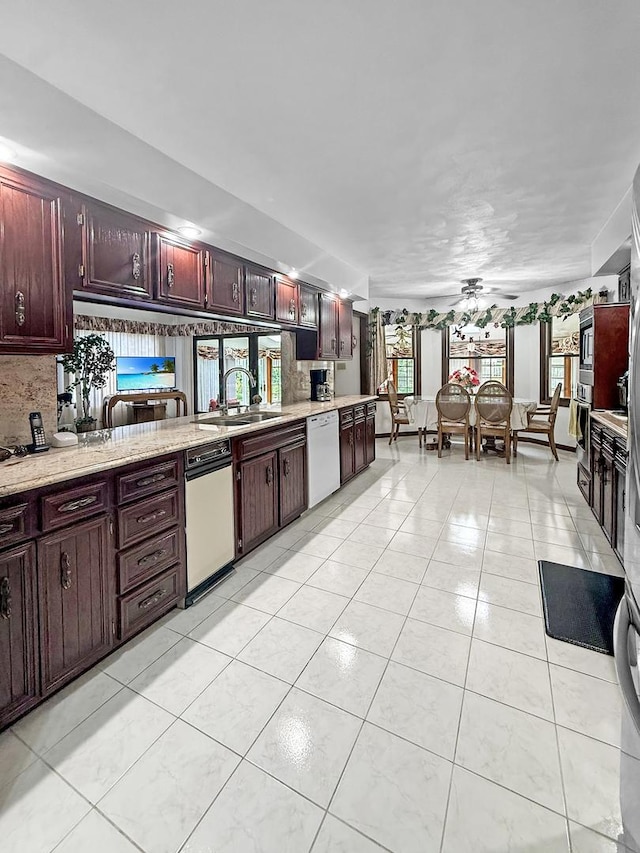1607 Parkside Ct, Freeport, IL 61032 - kitchen featuring dishwasher, reddish brown cabinets, healthy amount of natural light, and light tile patterned floors