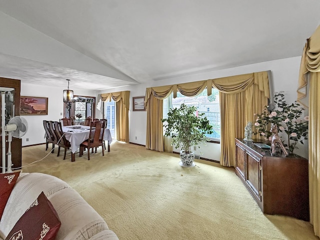 1607 Parkside Ct, Freeport, IL 61032 - dining room with light colored carpet, lofted ceiling, and a chandelier