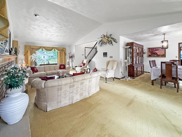 1607 Parkside Ct, Freeport, IL 61032 - carpeted living room with a chandelier, stairs, lofted ceiling, and a brick fireplace
