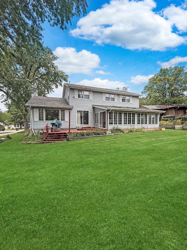 1607 Parkside Ct, Freeport, IL 61032 - rear view of property featuring a yard, a wooden deck, and a sunroom