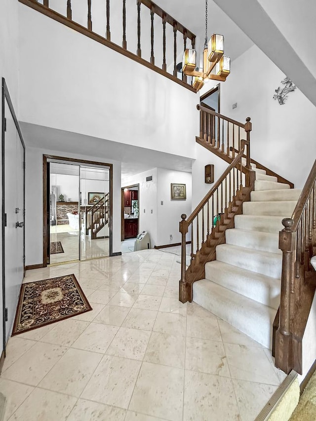1607 Parkside Ct, Freeport, IL 61032 - entryway featuring a high ceiling, stairway, and a chandelier