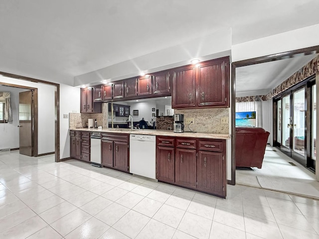 1607 Parkside Ct, Freeport, IL 61032 - kitchen featuring dishwasher, light countertops, backsplash, light tile patterned flooring, and dark brown cabinets
