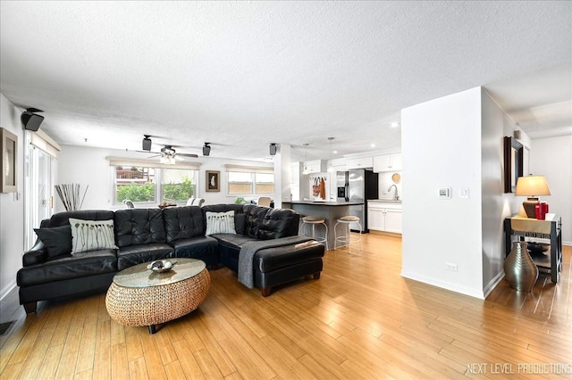 636 Cambridge Dr, Schaumburg, IL 60193 - living area with a textured ceiling, light wood-style floors, and ceiling fan