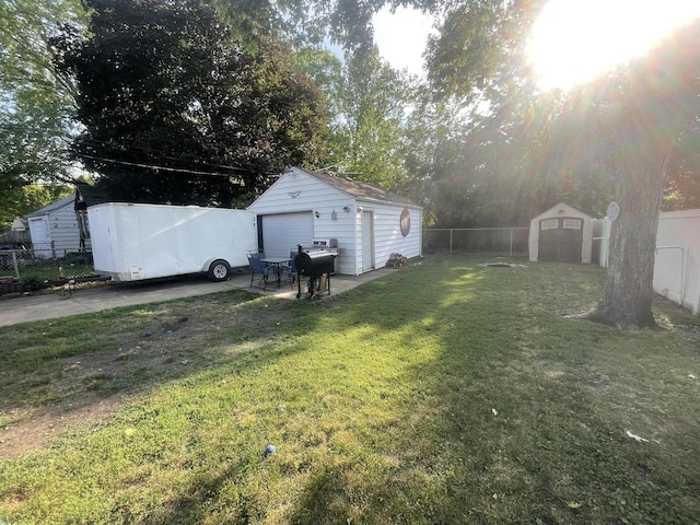111 Earl Ave, Joliet, IL 60436 - fenced backyard featuring a detached garage and a storage unit
