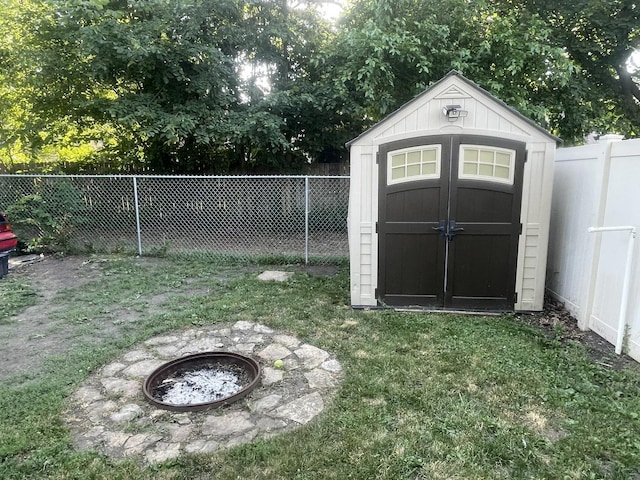 111 Earl Ave, Joliet, IL 60436 - view of shed featuring a fenced backyard and an outdoor fire pit