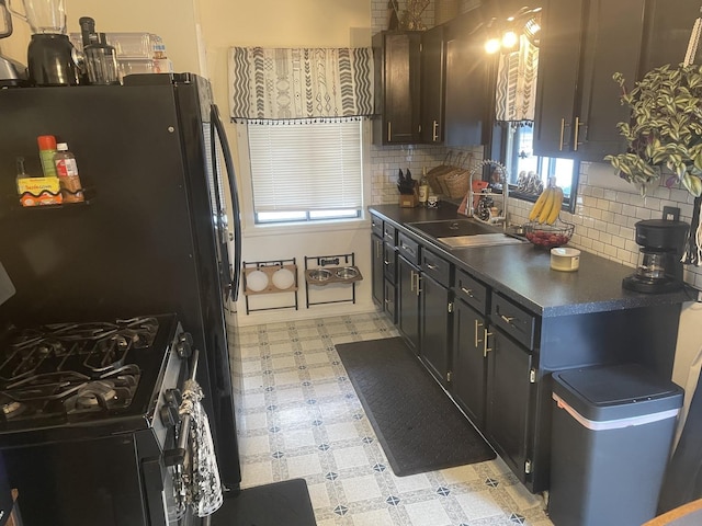 111 Earl Ave, Joliet, IL 60436 - kitchen featuring gas stove, light flooring, dark countertops, and decorative backsplash