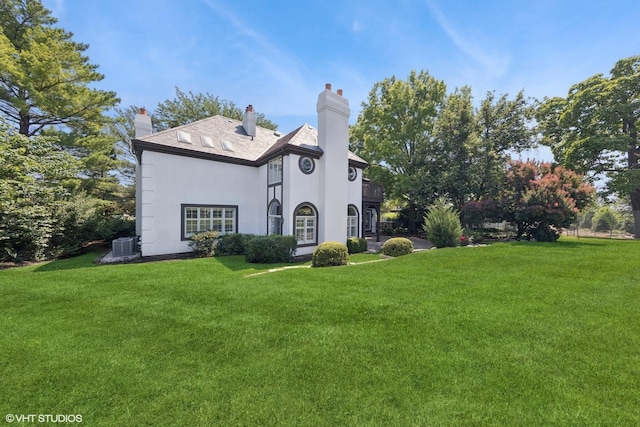 1604 Burr Ridge Clb, Burr Ridge, IL 60527 - view of front of house featuring stucco siding, a chimney, and a front yard