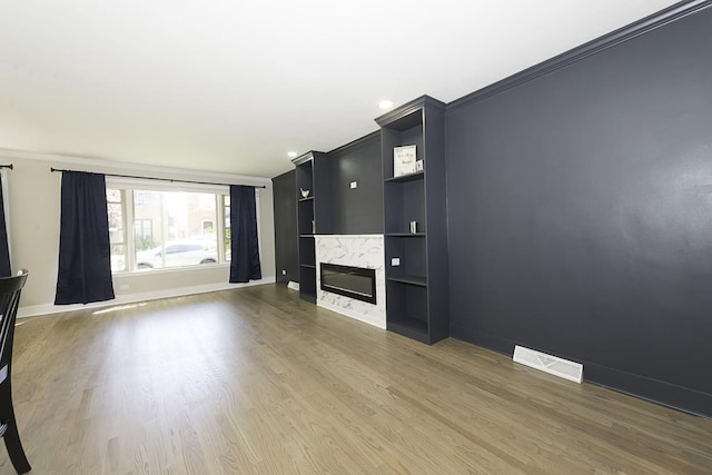 5848 N Drake Ave, Chicago, IL 60659 - unfurnished living room featuring wood finished floors, a high end fireplace, crown molding, built in features, and recessed lighting