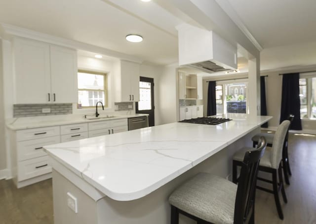 5848 N Drake Ave, Chicago, IL 60659 - kitchen with dark wood-style flooring, stainless steel dishwasher, white cabinetry, a breakfast bar area, and gas stovetop