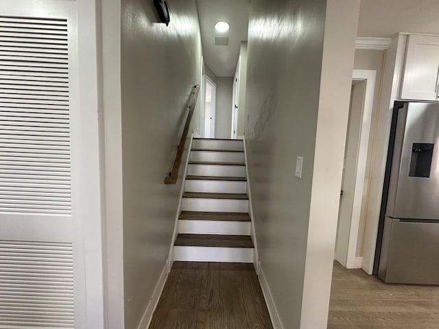 5848 N Drake Ave, Chicago, IL 60659 - staircase featuring a heating unit and wood finished floors