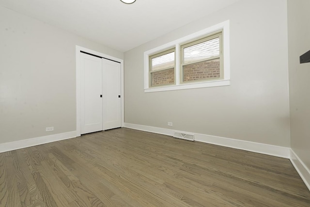 5848 N Drake Ave, Chicago, IL 60659 - unfurnished bedroom with wood finished floors and a closet