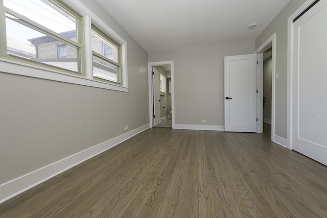 5848 N Drake Ave, Chicago, IL 60659 - unfurnished bedroom featuring dark wood-type flooring and connected bathroom