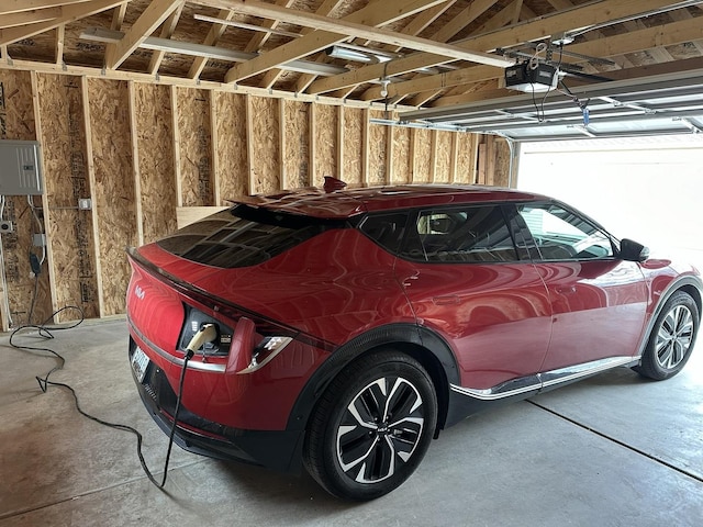 5848 N Drake Ave, Chicago, IL 60659 - garage featuring a garage door opener and electric panel