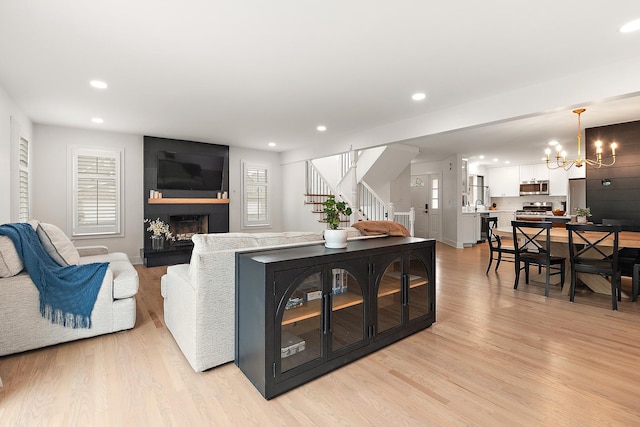 8378 Dunmore Dr, Tinley Park, IL 60487 - living room featuring a chandelier, stairs, recessed lighting, light wood-style floors, and a large fireplace