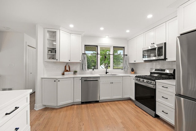 8378 Dunmore Dr, Tinley Park, IL 60487 - kitchen with appliances with stainless steel finishes, light wood-style floors, backsplash, light countertops, and recessed lighting
