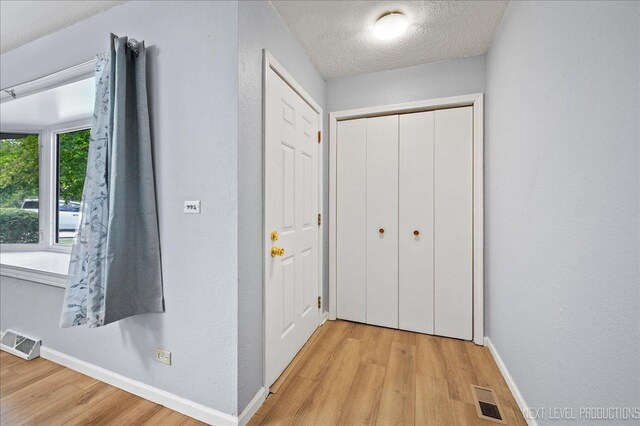1885 Monday Dr, Elgin, IL 60123 - corridor featuring light wood-style flooring and a textured ceiling