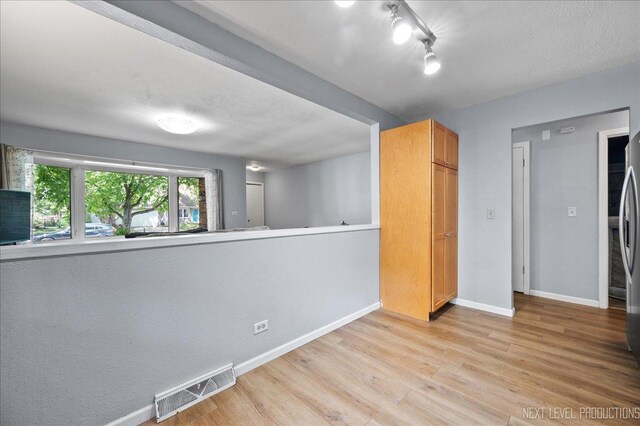 1885 Monday Dr, Elgin, IL 60123 - unfurnished bedroom featuring light wood finished floors and stainless steel refrigerator