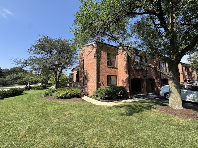 19W286 Governors Trl Unit 0, Oak Brook, IL 60523 - view of home's exterior featuring a yard and brick siding