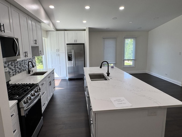 19W286 Governors Trl Unit 0, Oak Brook, IL 60523 - kitchen featuring stainless steel appliances, an island with sink, dark wood-type flooring, light stone countertops, and recessed lighting