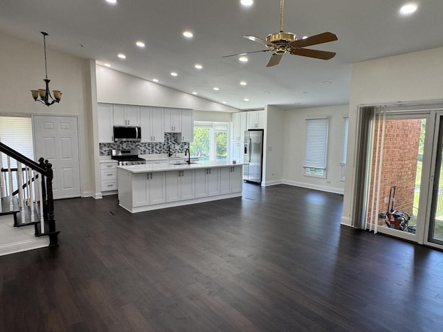 19W286 Governors Trl Unit 0, Oak Brook, IL 60523 - kitchen featuring appliances with stainless steel finishes, recessed lighting, light countertops, a chandelier, and an island with sink