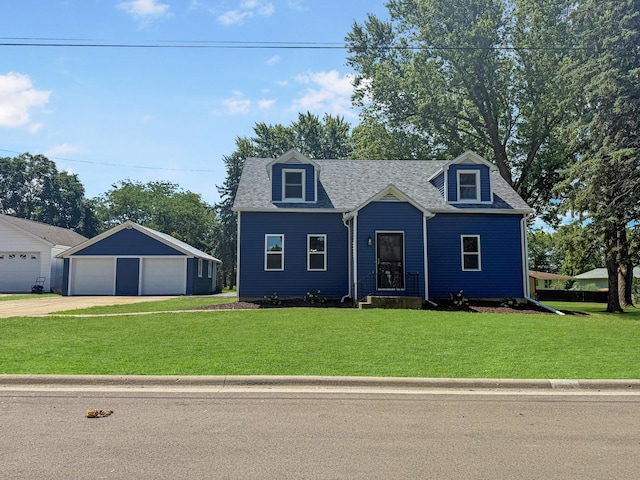 309 W S St, Pearl City, IL 61062 - cape cod home with a garage, a front yard, an outdoor structure, and roof with shingles