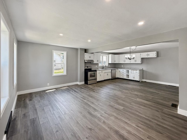 309 W S St, Pearl City, IL 61062 - unfurnished living room with dark wood finished floors, recessed lighting, a chandelier, and a baseboard radiator