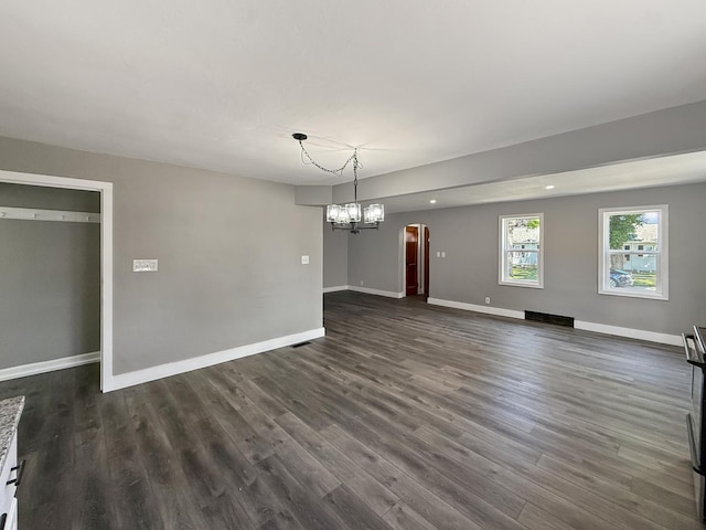309 W S St, Pearl City, IL 61062 - unfurnished dining area featuring arched walkways, dark wood finished floors, and a chandelier