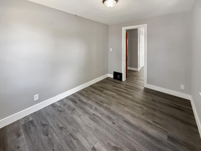 309 W S St, Pearl City, IL 61062 - spare room featuring baseboards and dark wood-style floors
