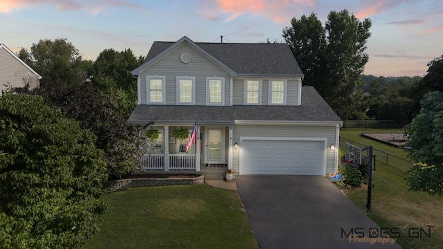203 Stearn Dr, Genoa, IL 60135 - traditional-style home with covered porch, asphalt driveway, and roof with shingles
