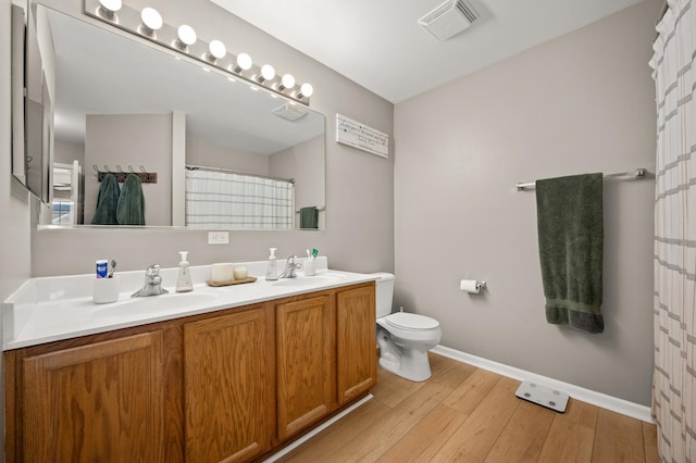 203 Stearn Dr, Genoa, IL 60135 - bathroom with double vanity, wood finished floors, and a shower with curtain
