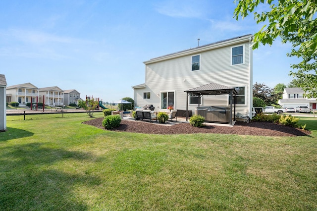 203 Stearn Dr, Genoa, IL 60135 - back of property featuring a gazebo, a patio, a lawn, and an outdoor living space