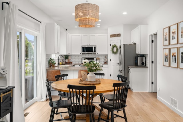 203 Stearn Dr, Genoa, IL 60135 - dining space with a chandelier, light wood-style floors, and recessed lighting