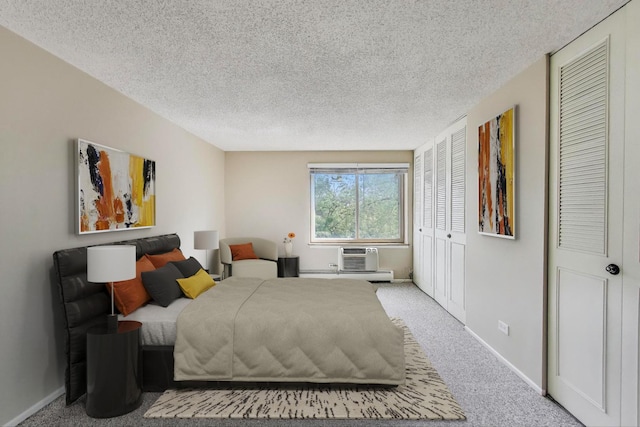 1227 S Old Wilke Rd Unit 304, Arlington Heights, IL 60005 - bedroom featuring a textured ceiling, carpet floors, and a wall mounted air conditioner