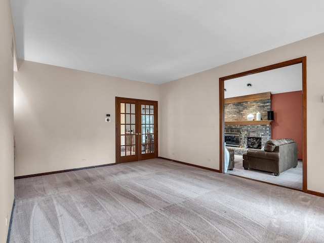 231 Deer Ln, Sleepy Hollow, IL 60118 - empty room with french doors, carpet flooring, and a brick fireplace