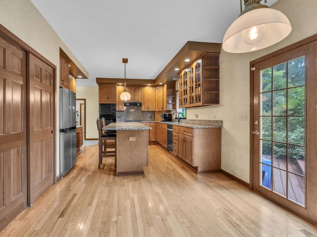 231 Deer Ln, Sleepy Hollow, IL 60118 - kitchen featuring black appliances, open shelves, light wood-style floors, a breakfast bar area, and tasteful backsplash