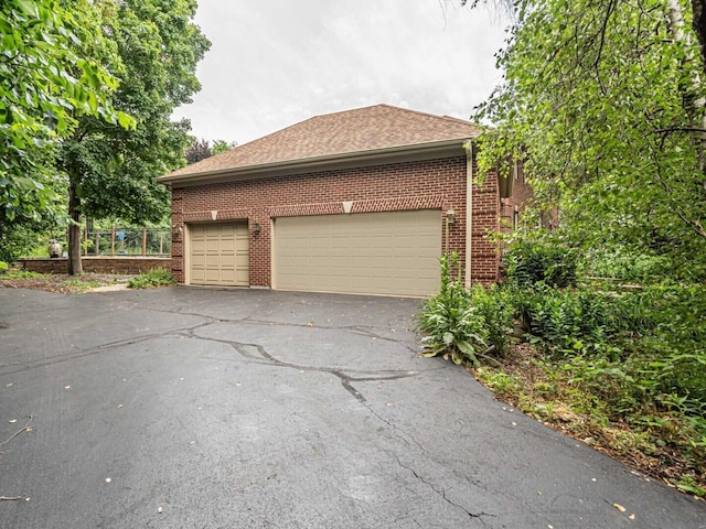 231 Deer Ln, Sleepy Hollow, IL 60118 - view of home's exterior with brick siding, driveway, and a garage
