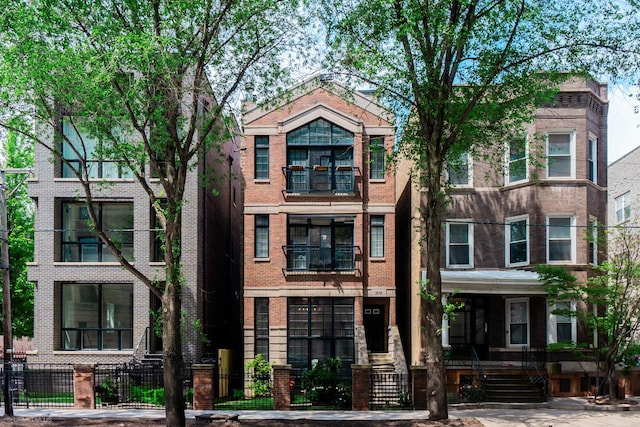 2418 N Southport Ave Unit 1, Chicago, IL 60614 - view of property with brick siding and a fenced front yard
