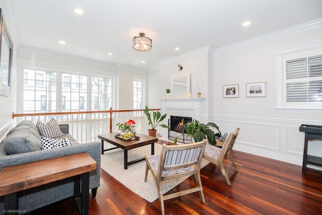 2418 N Southport Ave Unit 1, Chicago, IL 60614 - living room with dark wood-style floors, a lit fireplace, ornamental molding, recessed lighting, and wainscoting