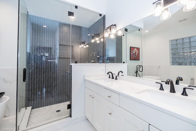 2418 N Southport Ave Unit 1, Chicago, IL 60614 - bathroom with double vanity, marble look tile flooring, a soaking tub, a shower stall, and tile walls