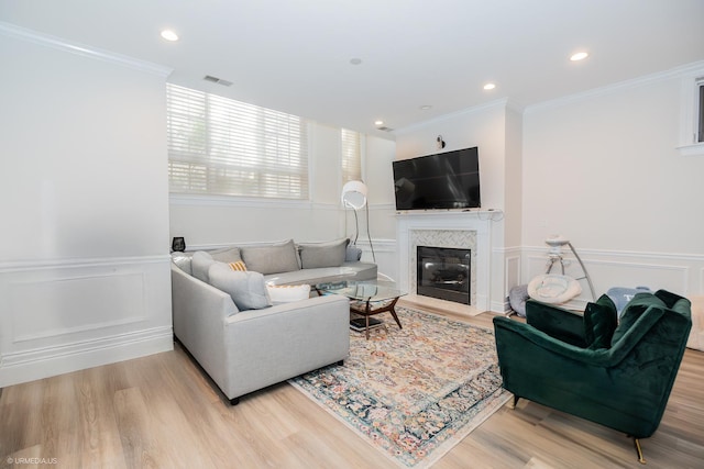 2418 N Southport Ave Unit 1, Chicago, IL 60614 - living area with a wainscoted wall, a decorative wall, light wood finished floors, a fireplace with flush hearth, and ornamental molding
